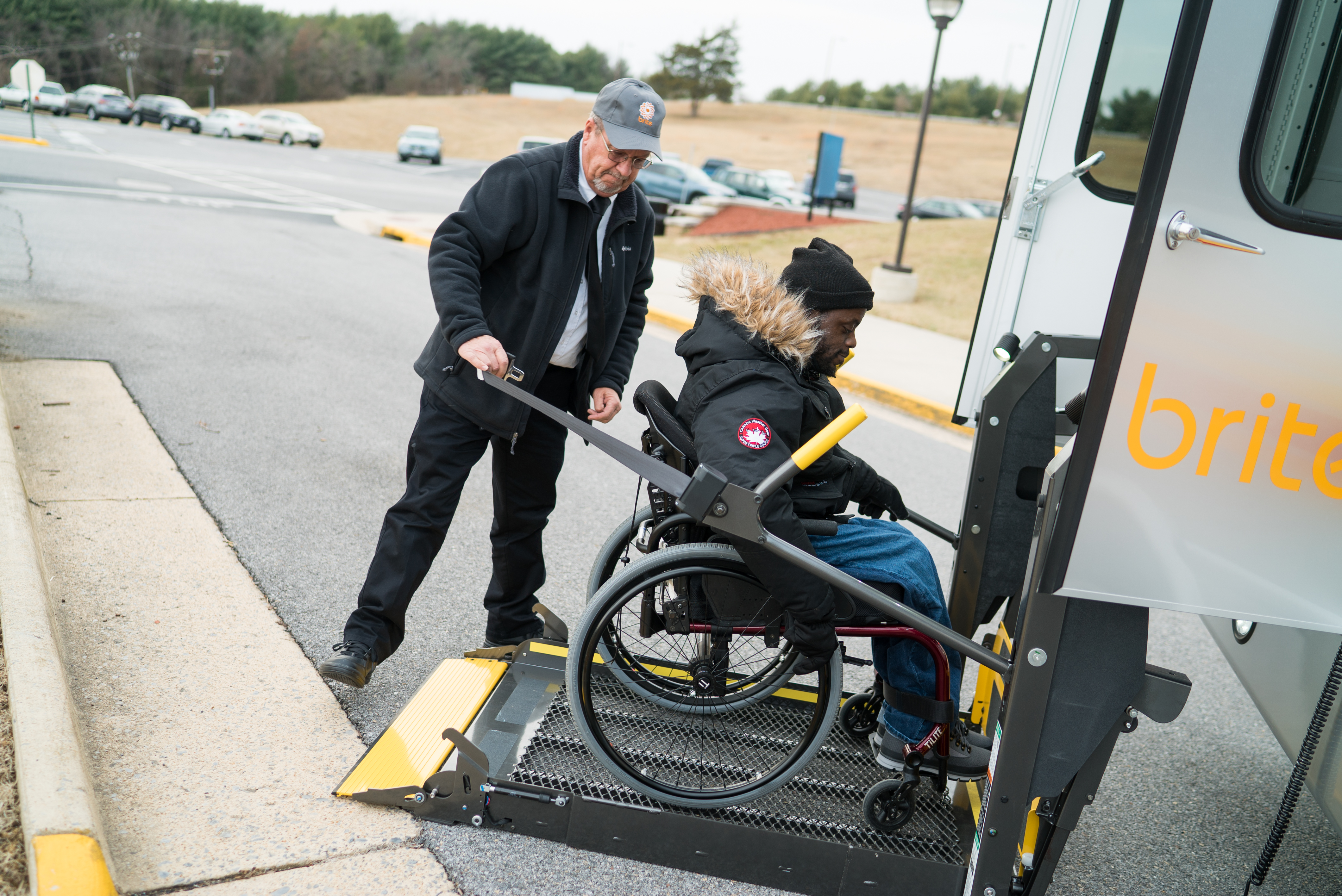 brite bus driver helping passenger with disability