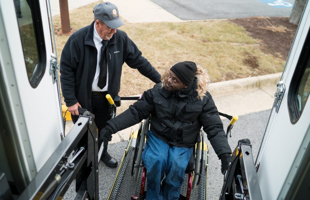 brite bus driver helping out handicapped passenger