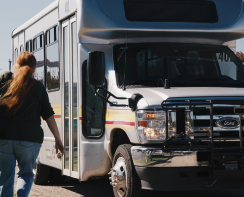 Woman walking toward bus